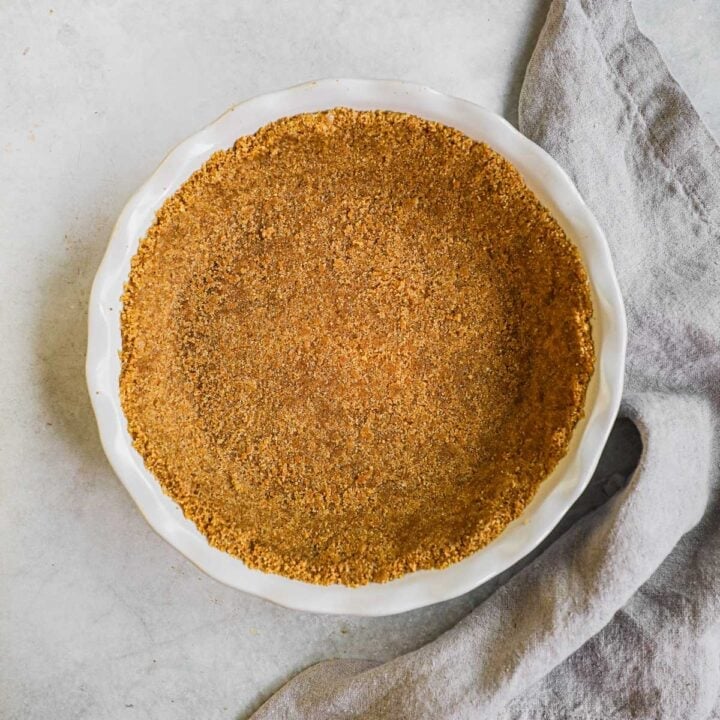 Homemade graham cracker crust in an Emile Henry pie dish for pies, cheesecakes, and more.