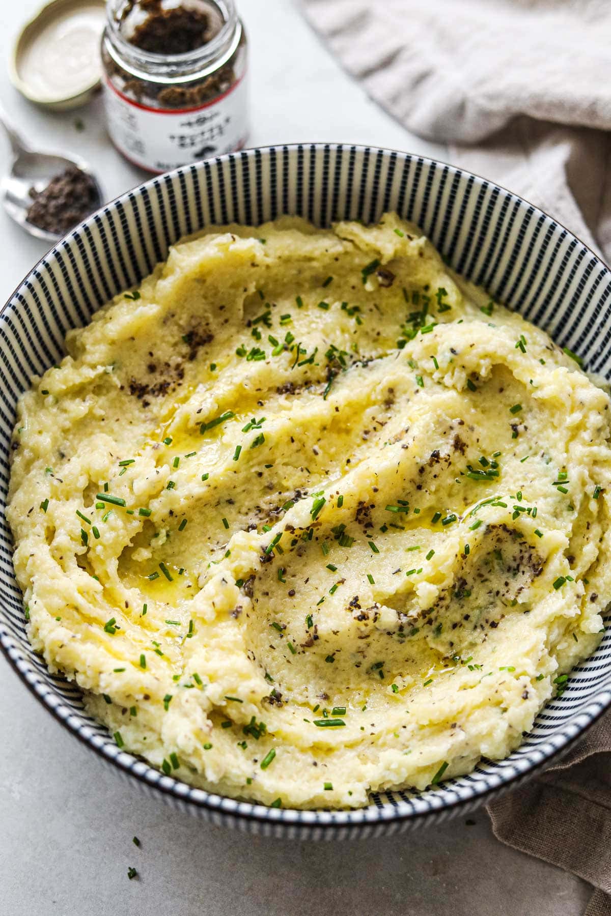 Creamy truffle mashed potatoes with swoops of melted butter on top.