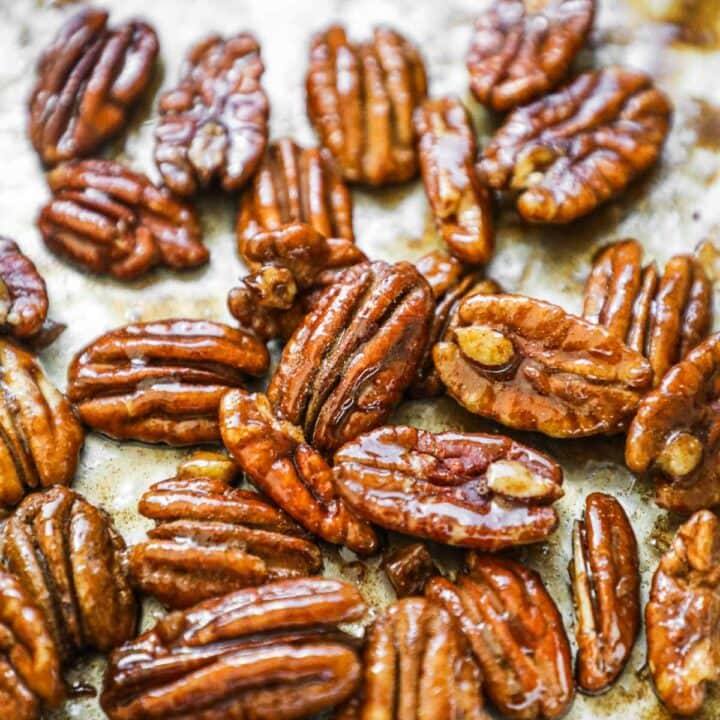 Maple-glazed candied pecans in a pan.
