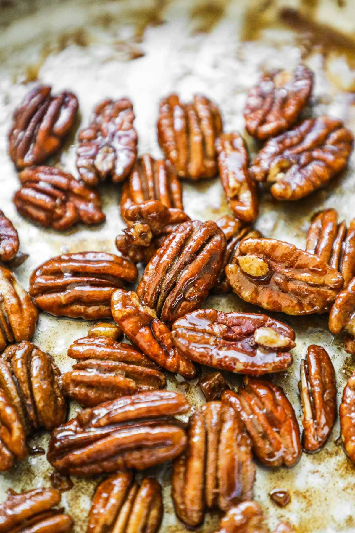 Maple-glazed candied pecans in a pan.