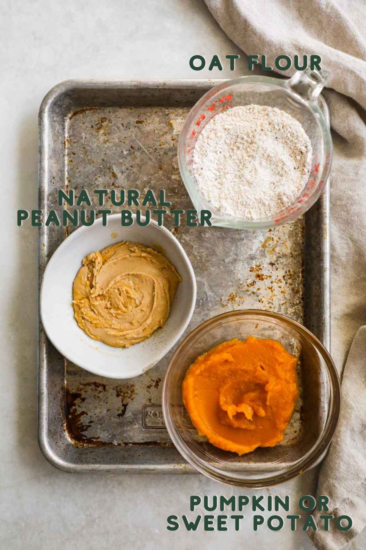 Ingredients for 3-ingredient dog biscuits, oat flour, natural peanut butter, and pumpkin or sweet potato.