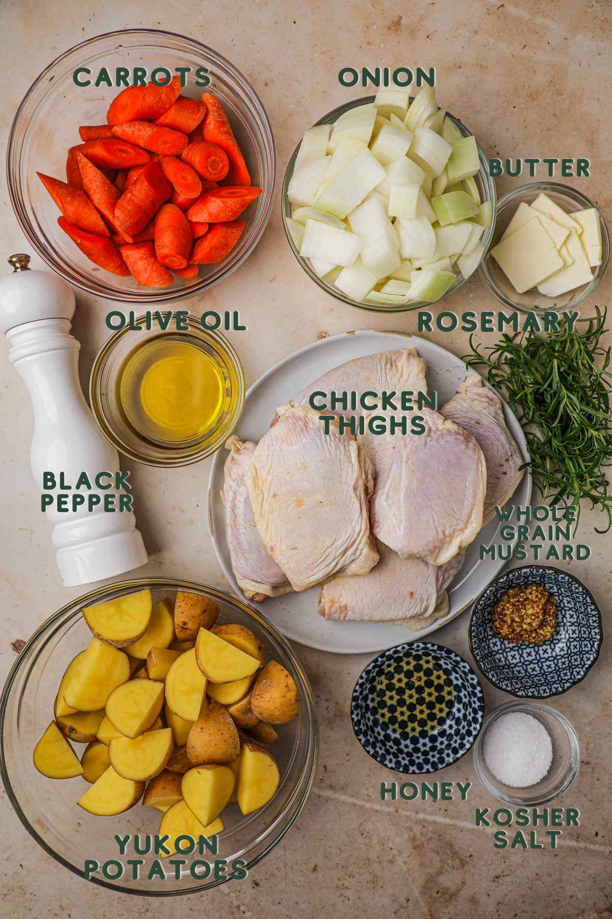 Ingredients for rosemary chicken thighs, chicken thighs, carrots, onion, potatoes, olive oil, rosemary, mustard, honey, salt, pepper.