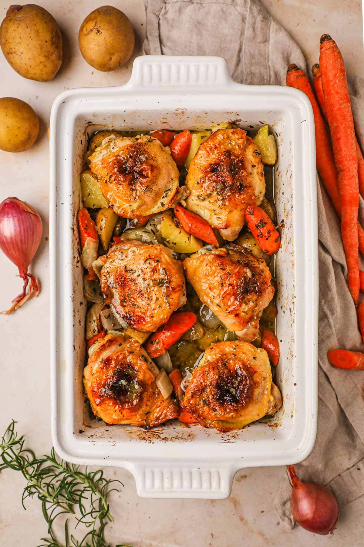 Roasted chicken thighs with crispy skin and vegetables roasted in an olive oil, whole grain dijon mustard, honey, and rosemary.