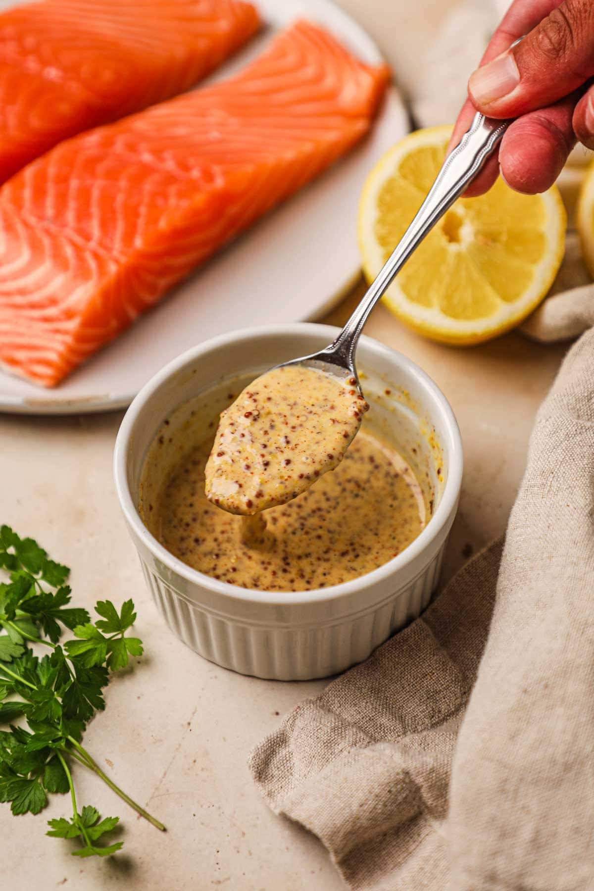 Honey garlic dijonnaise made with whole grain mustard in a ramekin for sandwiches, chicken, fish, and more.