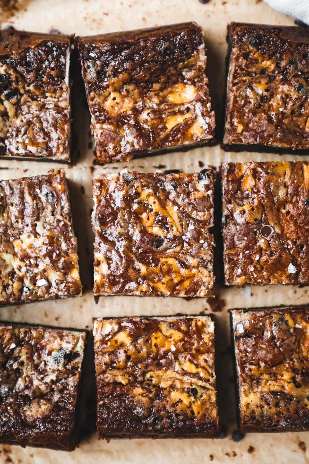 Flatlay of marbled cheesecake brownies made with brown butter and chocolate chips.