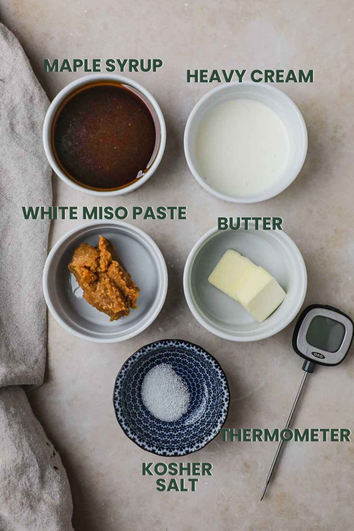 Ingredients to make miso maple caramel sauce, maple syrup, heavy cream, white miso paste, butter, kosher salt, thermometer.