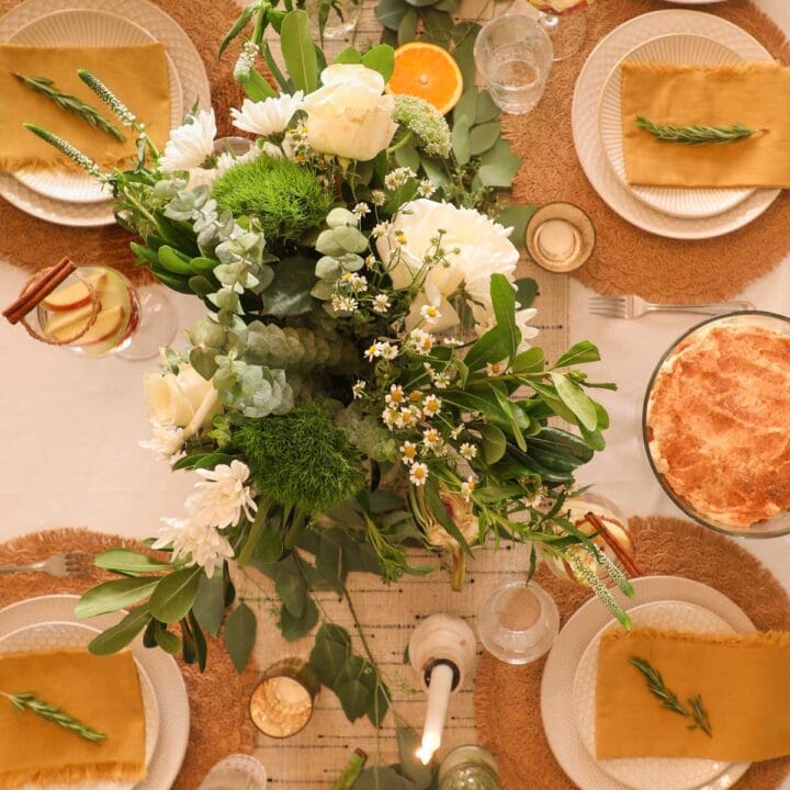 Host a stress-free Thanksgiving with a beautiful tablescape with flowers, linens, placemats, glasses, and dishes.