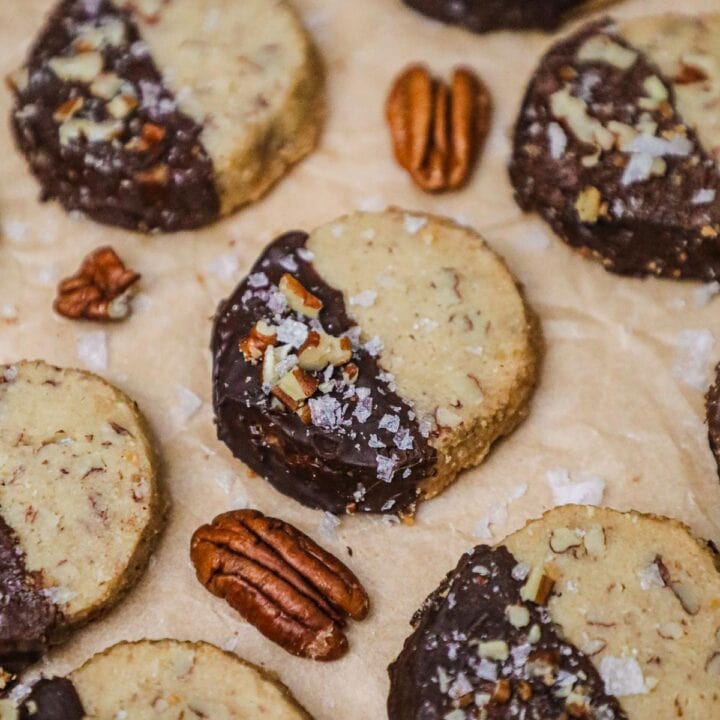 Chocolate-dipped brown sugar pecan shortbread topped with chopped pecans and flaky sea salt.