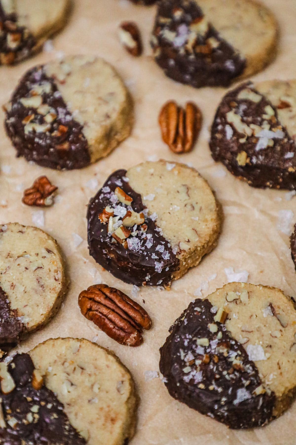 Chocolate-dipped brown sugar pecan shortbread topped with chopped pecans and flaky sea salt.