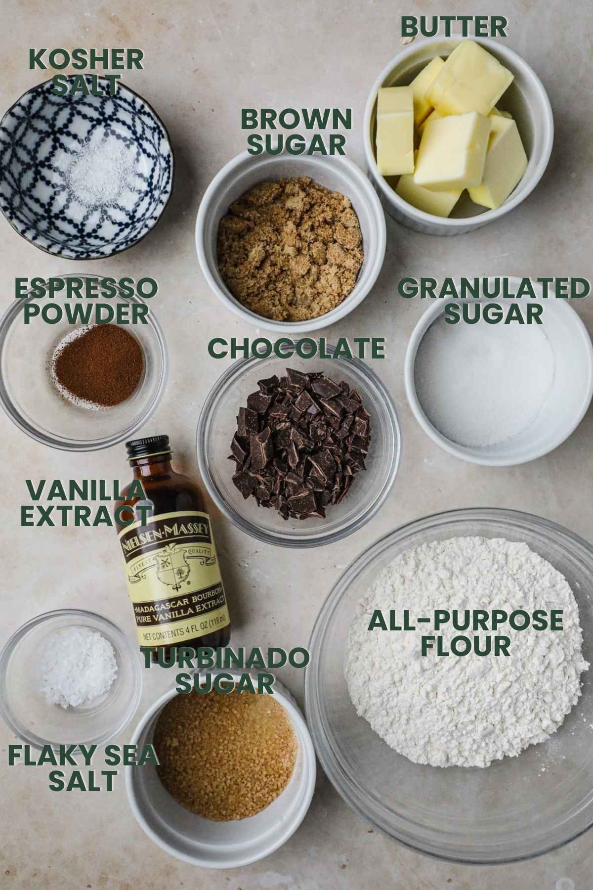 Ingredients for chocolate chunk brown butter shortbread, flour, brown sugar, granulated sugar, butter, kosher salt, espresso powder, vanilla extract, flaky sea salt.