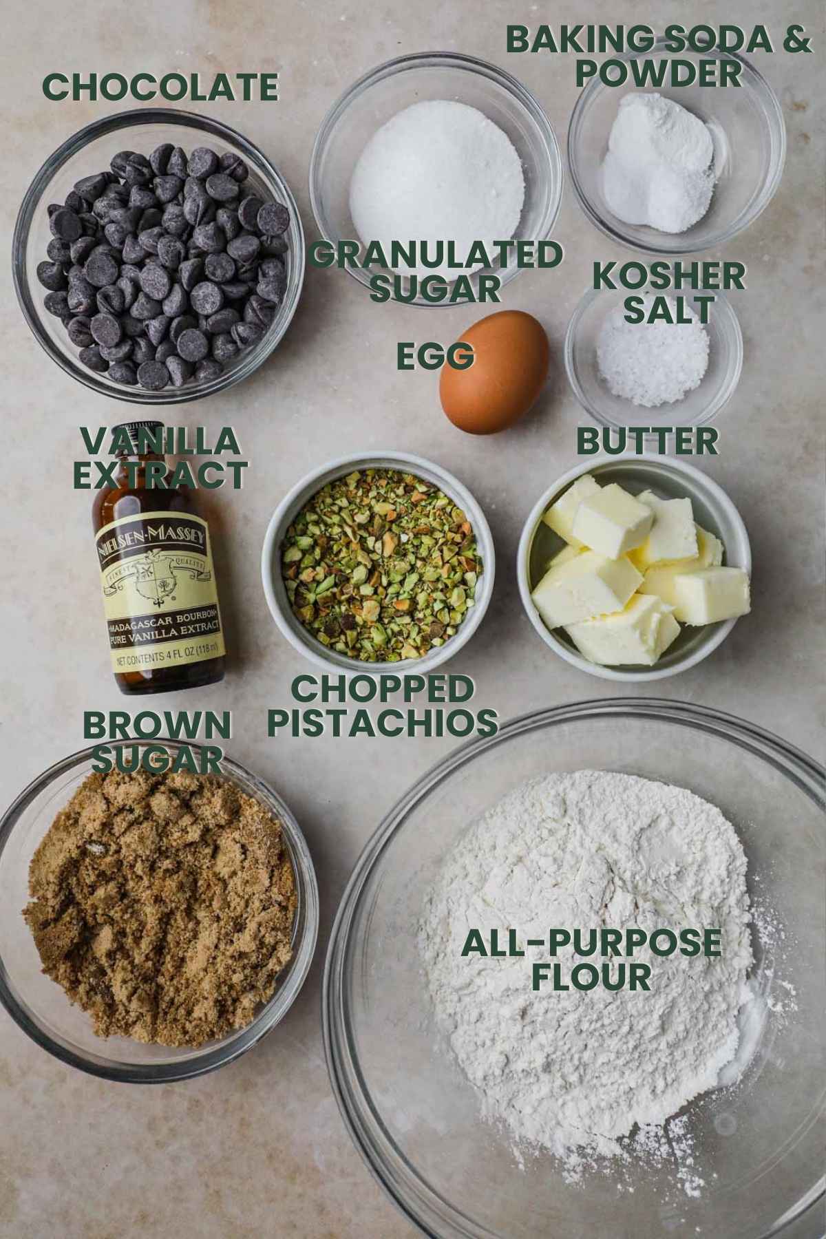 Ingredients to make pistachio chocolate chip cookies, flour, pistachios, brown and granulated sugar, baking soda and powder, kosher salt, egg, vanilla, chocolate.