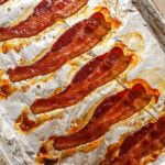 No-splatter easy oven-baked bacon on an aluminum foil-lined sheet pan.