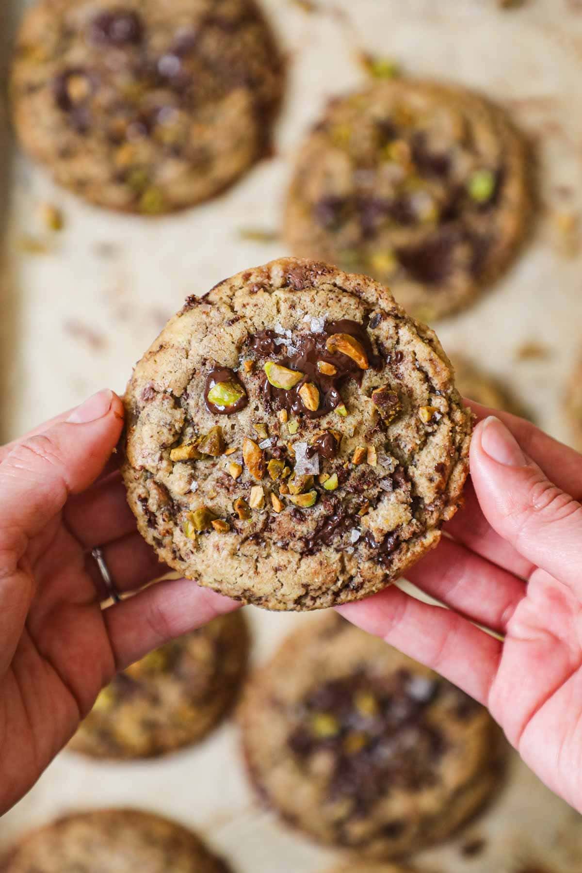 Salted brown butter pistachio chocolate chunk cookies with melted chocolate.